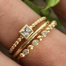 Load image into Gallery viewer, Our dainty diamond dot eternity band is simple and beautiful. You can wear it alone for a minimalist look or as part of a stack for a boho chic look. Jewelry that is 925 sterling silver with rhodium or 18K gold plating Diamonds at AAA cubic zirconia