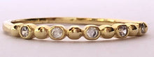 Load image into Gallery viewer, Our dainty diamond dot eternity band is simple and beautiful. You can wear it alone for a minimalist look or as part of a stack for a boho chic look. Jewelry that is 925 sterling silver with rhodium or 18K gold plating Diamonds at AAA cubic zirconia