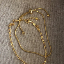 Load image into Gallery viewer, This beautiful adjustable snake bracelet is so easy to wear you’ll never want to take it off. It goes with any outfit or bracelet stack. It’s truly a jewelry staple!   18k gold plated stainless steel  8.5in max length  water resistant