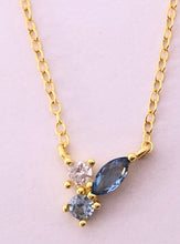 Load image into Gallery viewer, Our Dainty Blue Stone Cluster necklace is perfect to wear alone everyday to add a little shine to any look. It can also be the finishing touch to any layered stack.      925 sterling silver with platinum or 18K gold plating     Stones are AAAA cubic zirconia in white, light blue, and dark blue     16 inch chain with adjustable extender
